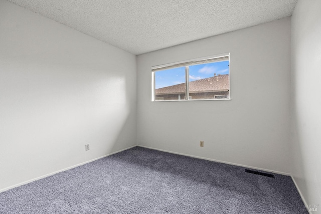 empty room featuring baseboards, visible vents, carpet flooring, and a textured ceiling