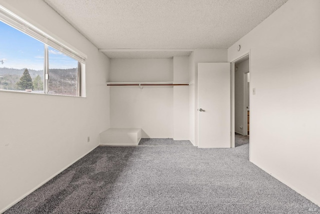 unfurnished bedroom with a closet, carpet floors, and a textured ceiling