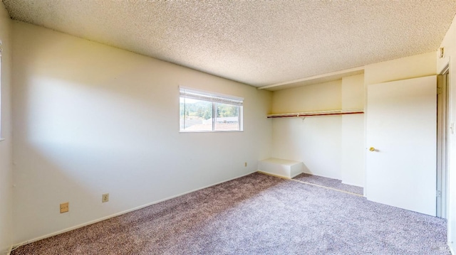 unfurnished bedroom featuring carpet floors and a textured ceiling