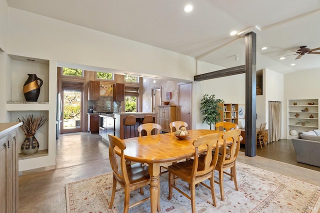 dining room with ceiling fan and built in shelves