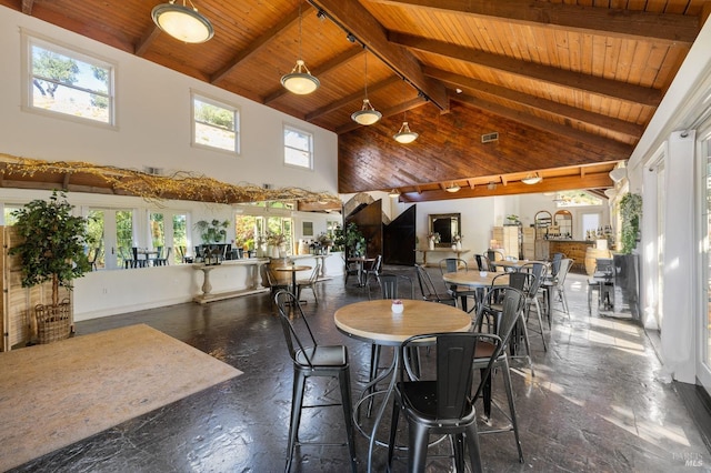 dining area with high vaulted ceiling, beam ceiling, wooden ceiling, and a healthy amount of sunlight