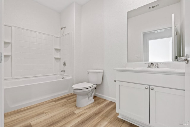 full bathroom featuring shower / bath combination, vanity, hardwood / wood-style floors, and toilet