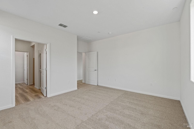 unfurnished bedroom featuring light carpet