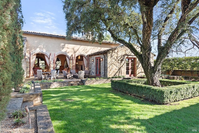 view of front of home with a front lawn and a patio area