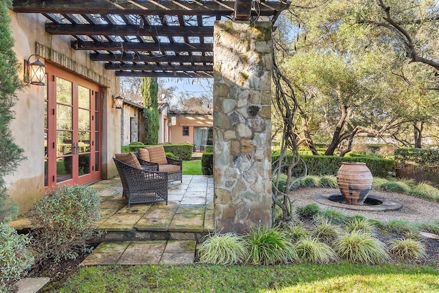 view of patio with french doors and a pergola