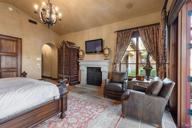 bedroom with a notable chandelier, light tile floors, and lofted ceiling