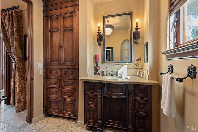 bathroom with vanity and tile flooring