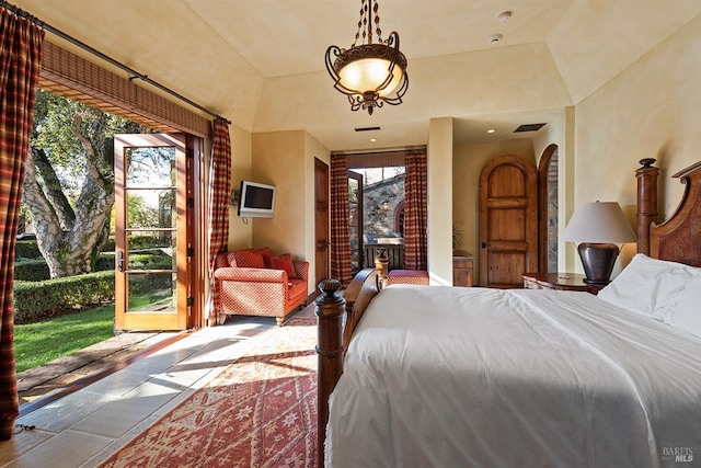 bedroom featuring multiple windows and a raised ceiling