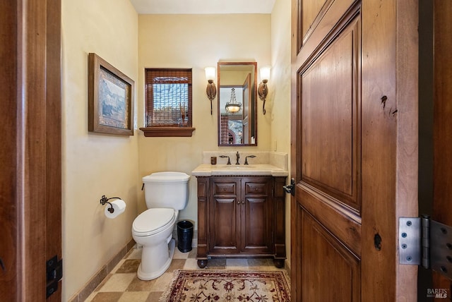 bathroom featuring toilet, large vanity, and tile flooring