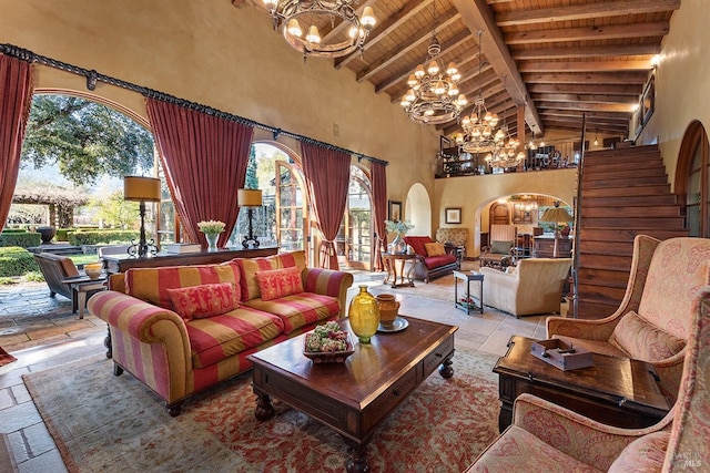 tiled living room with an inviting chandelier, beam ceiling, high vaulted ceiling, and a wealth of natural light