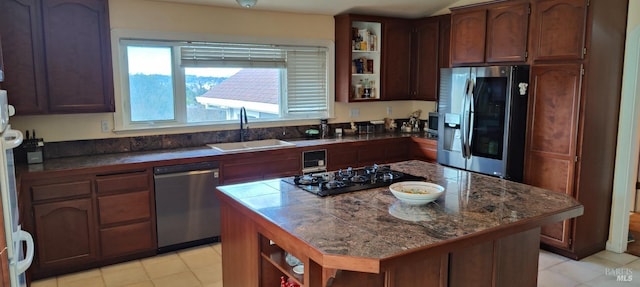 kitchen featuring a kitchen island, sink, dark brown cabinetry, and stainless steel appliances