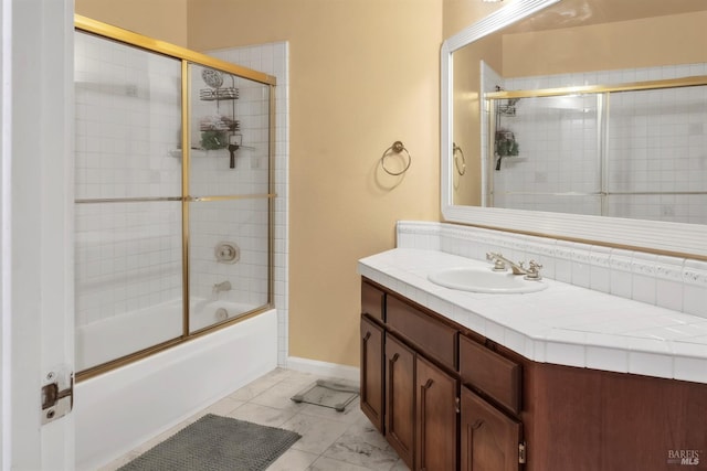 bathroom featuring vanity and shower / bath combination with glass door