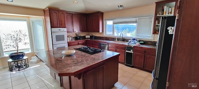 kitchen featuring a healthy amount of sunlight, sink, a center island, and stainless steel appliances