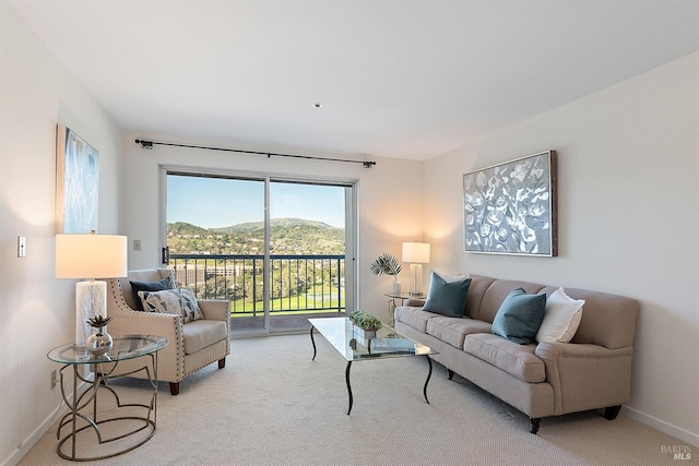 carpeted living room featuring a mountain view