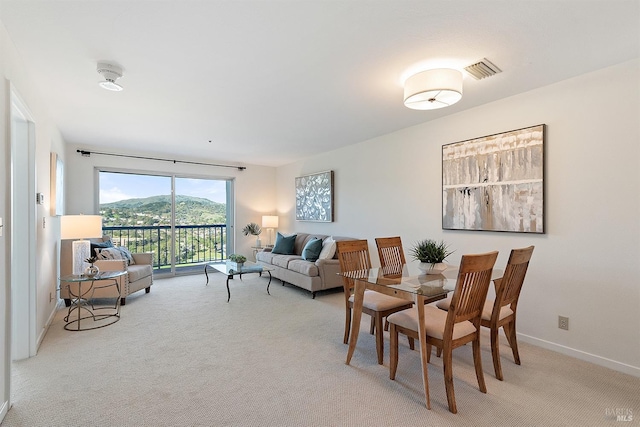 dining space with light colored carpet