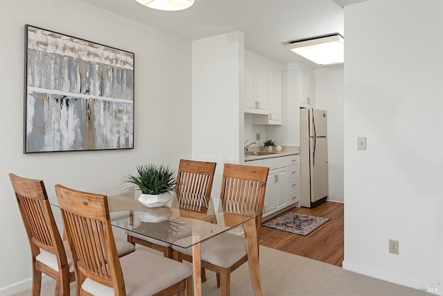 dining room featuring light hardwood / wood-style flooring and sink