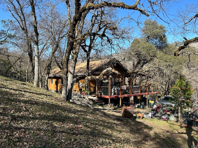 back of house featuring a wooden deck