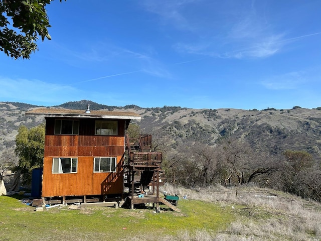 rear view of property featuring a mountain view