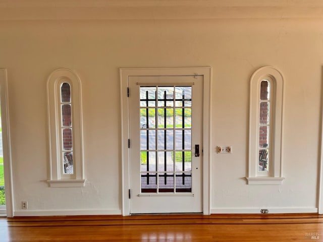 doorway with hardwood / wood-style flooring