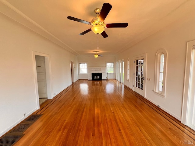 unfurnished living room featuring ceiling fan and light wood-type flooring