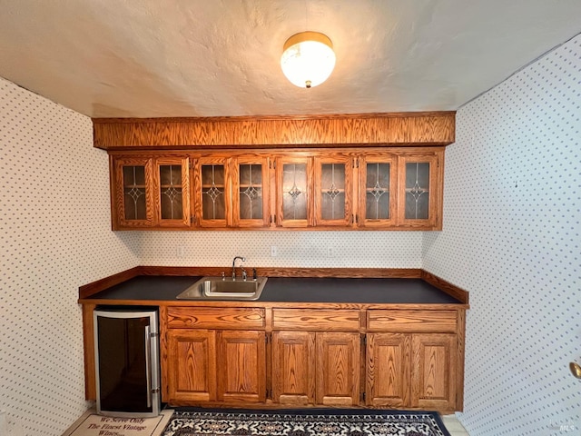 kitchen featuring wine cooler, sink, and light tile flooring