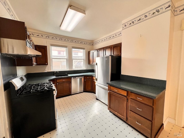 kitchen with sink, appliances with stainless steel finishes, and light tile flooring