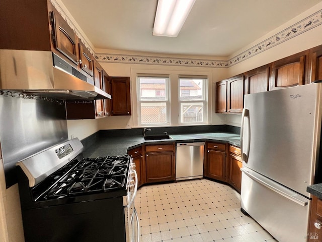 kitchen featuring sink, stainless steel appliances, and light tile floors