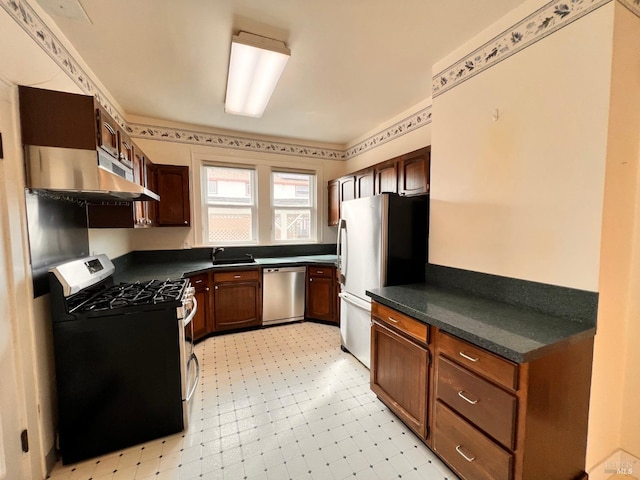 kitchen featuring light tile flooring, sink, and stainless steel appliances