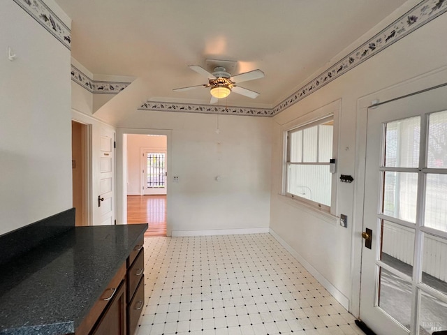 interior space with tile floors and ceiling fan