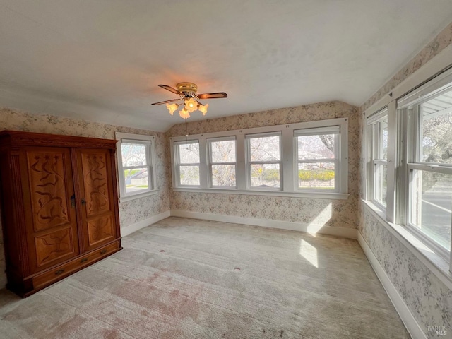 interior space featuring vaulted ceiling and ceiling fan