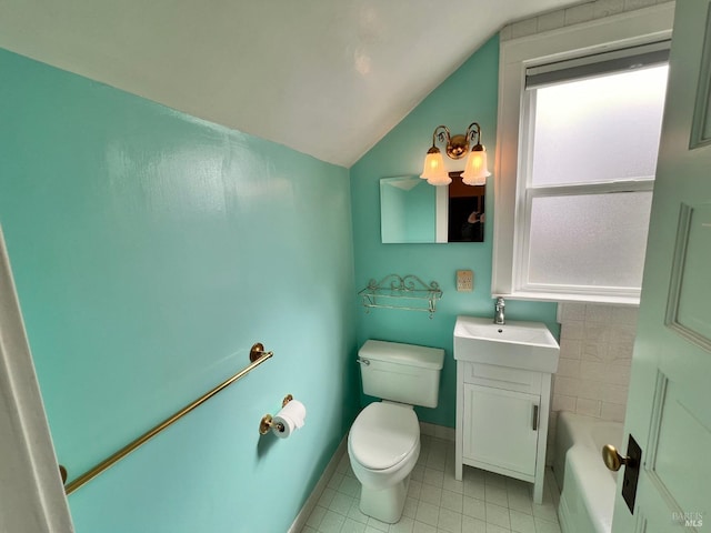 bathroom with vanity, tile flooring, vaulted ceiling, and toilet