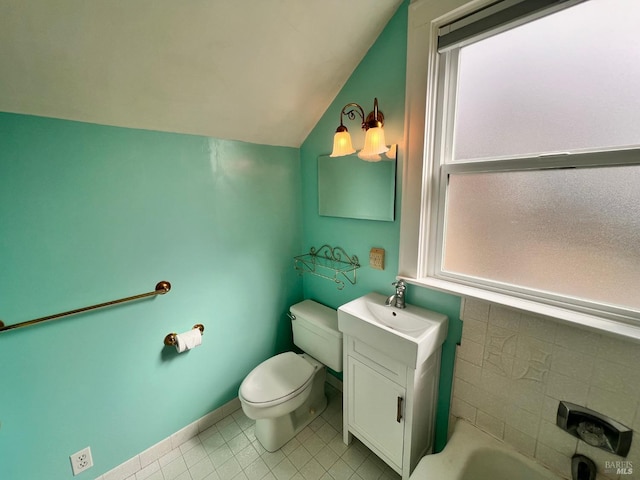 full bathroom with toilet, vanity, shower / tub combination, tile floors, and vaulted ceiling