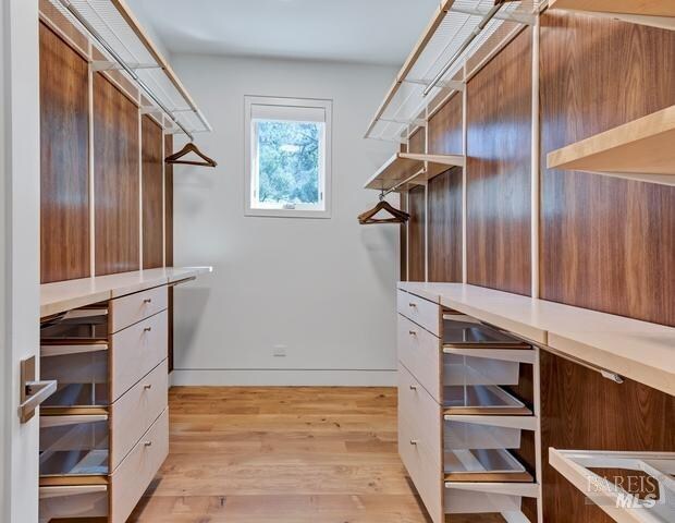 walk in closet featuring light hardwood / wood-style floors