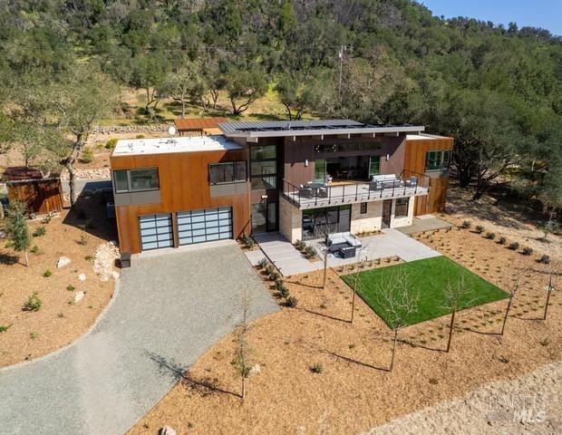 contemporary house with a patio and a garage