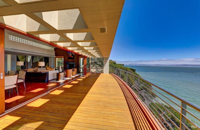 deck with outdoor lounge area and a water view