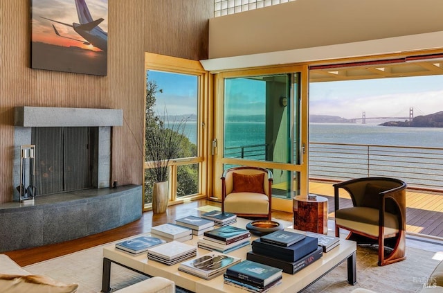 living room featuring a water view and light hardwood / wood-style flooring