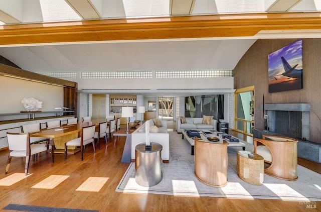 living room with lofted ceiling and light hardwood / wood-style flooring