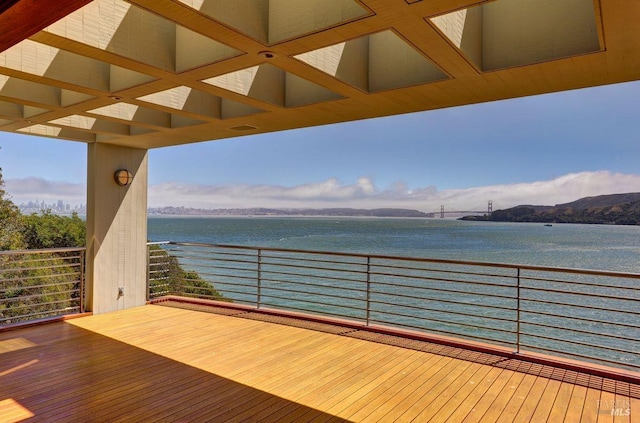 wooden terrace featuring a water view