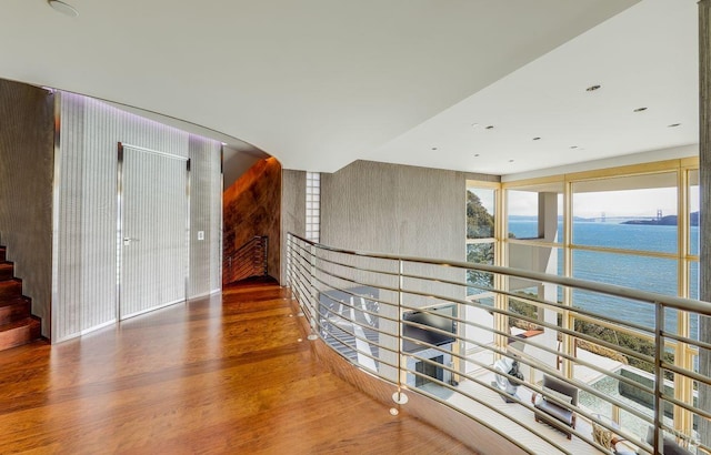 hallway featuring a water view and dark hardwood / wood-style flooring