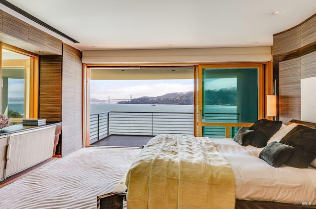 bedroom with a water view and access to exterior