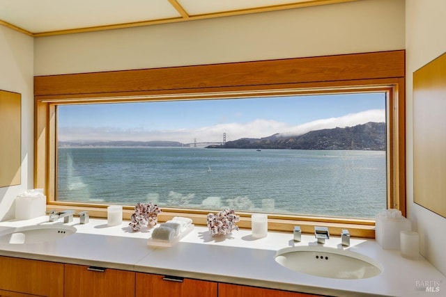 bathroom with a water and mountain view and double sink vanity