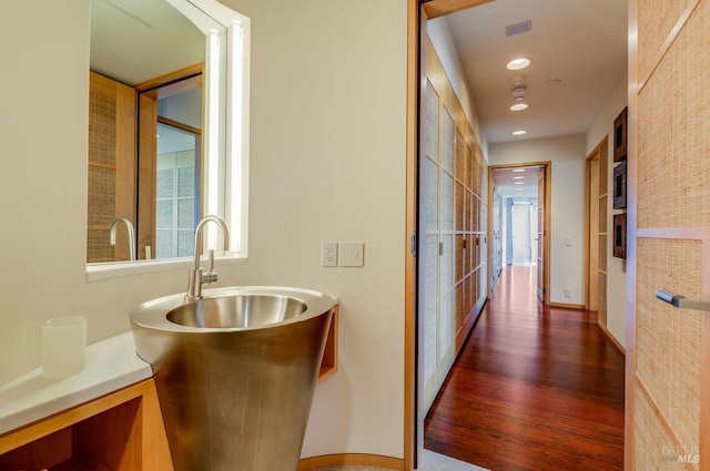 hallway with dark hardwood / wood-style floors and sink