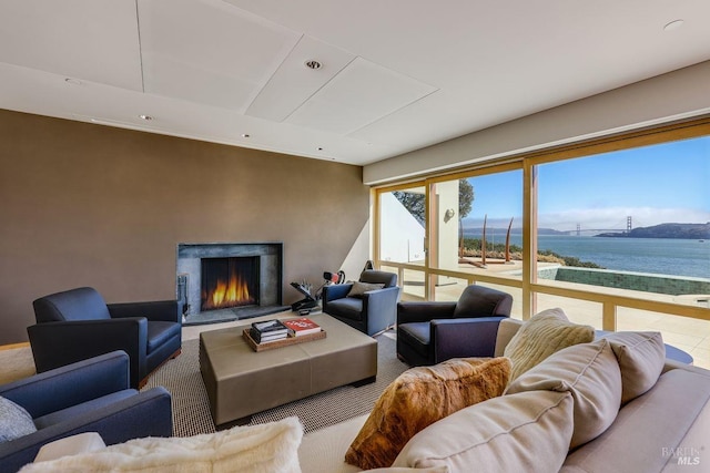 carpeted living room with a water view