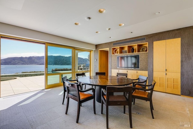 tiled dining area featuring a water and mountain view