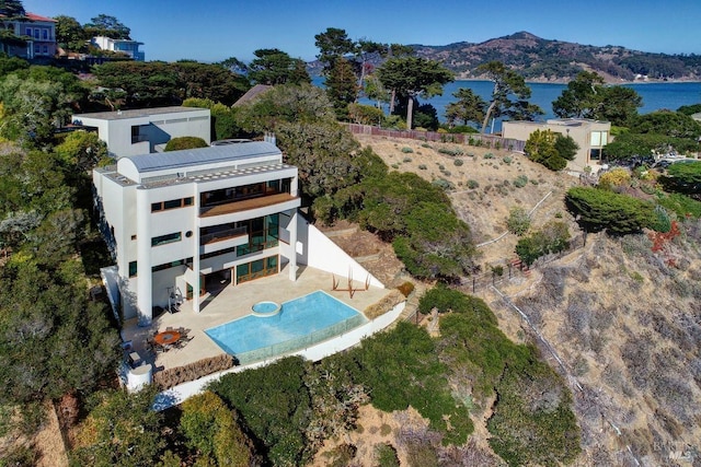 birds eye view of property with a water and mountain view