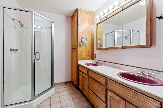 bathroom with tile patterned flooring, walk in shower, and vanity