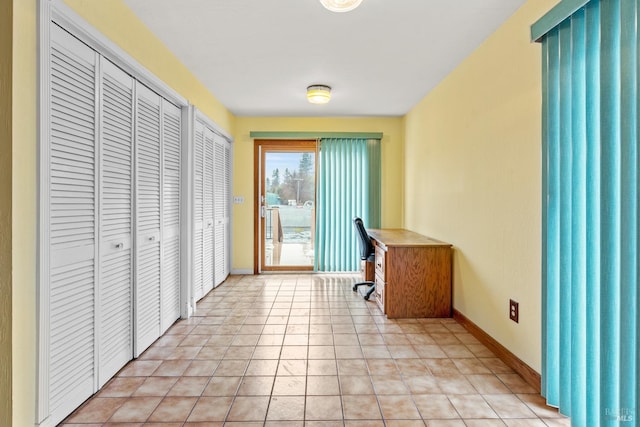 unfurnished office with light tile patterned floors