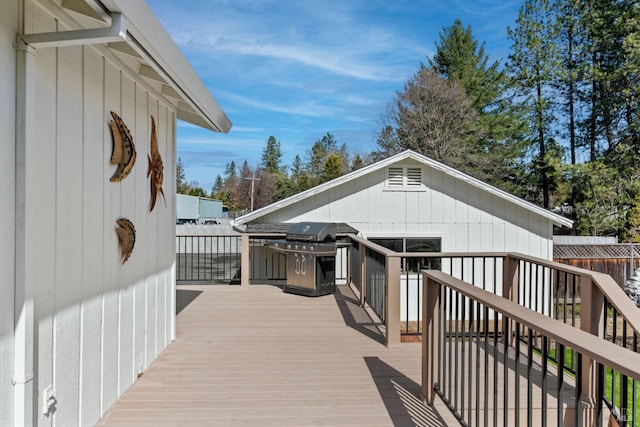 wooden terrace featuring a grill