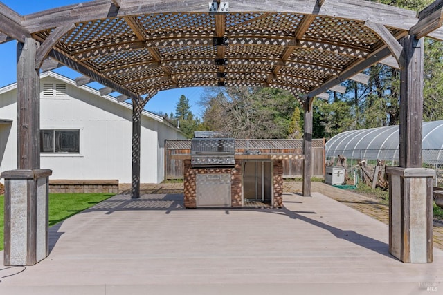 view of patio featuring a pergola, area for grilling, and a wooden deck