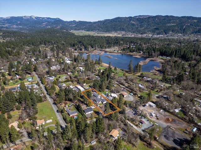 aerial view featuring a water and mountain view